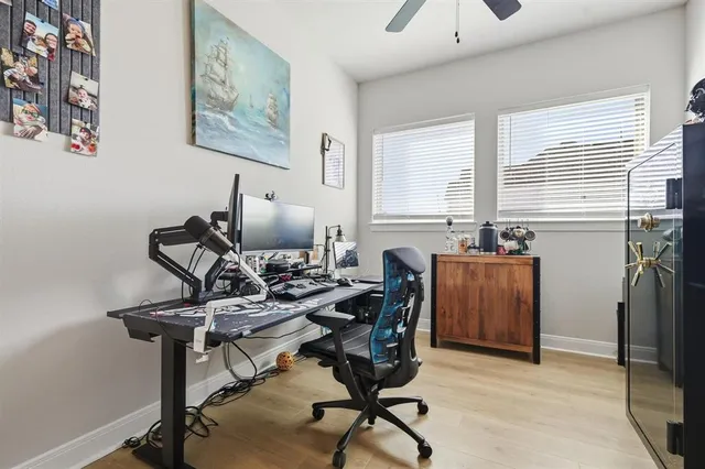 a view of a workspace with furniture and a window