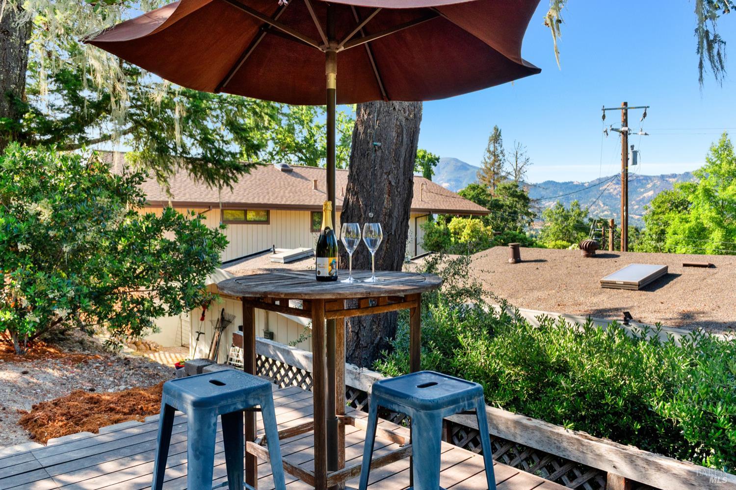 304 High Street Calistoga, CA 94515 - Photo 9 of 53 a view of a backyard with table and chairs under an umbrella