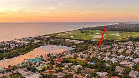 an aerial view of a houses with a lake