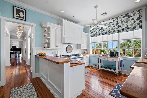 a kitchen with a stove a refrigerator and a table
