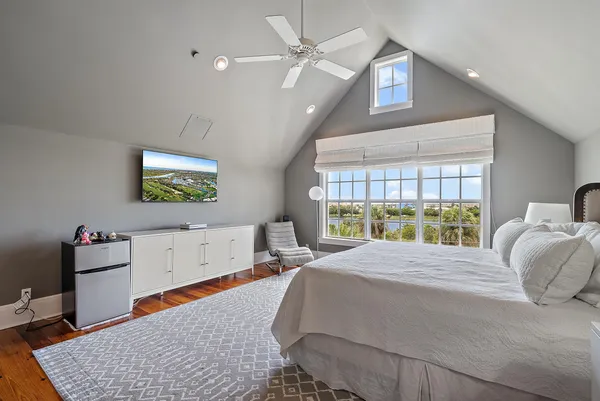 a bedroom with a bed and a chandelier