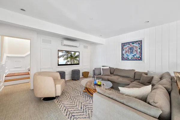 a living room with kitchen and furniture