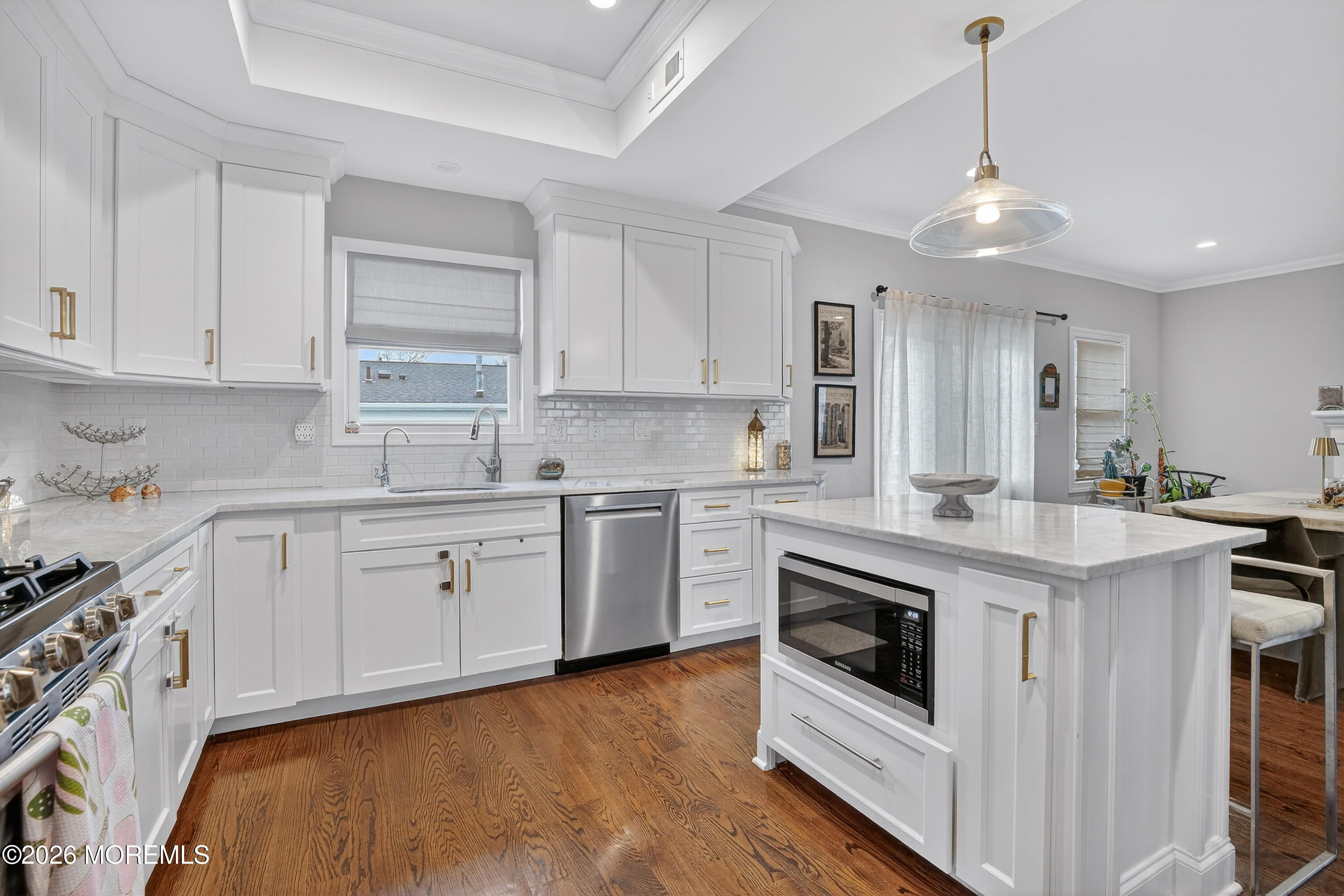 27 5th Street Highlands, NJ 07732 - Photo 6 of 62 a kitchen with stainless steel appliances granite countertop a stove a sink and white cabinets