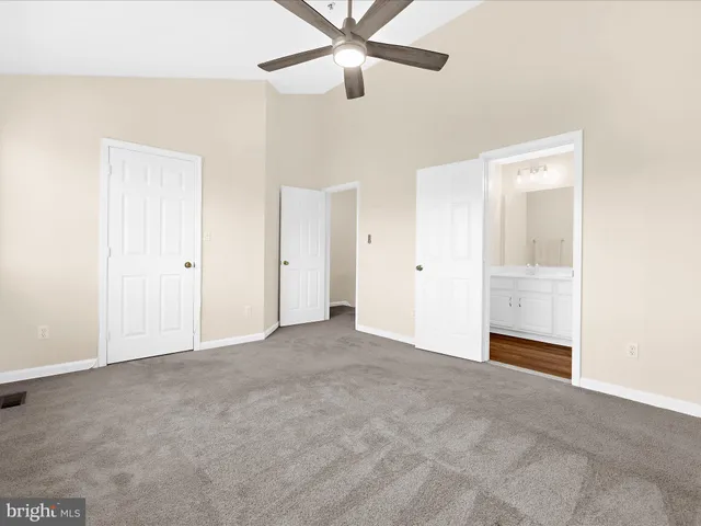 a bedroom with a bed and a potted plant