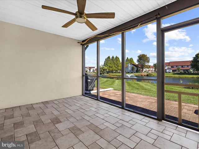 a view of a porch with a floor to ceiling window and a yard