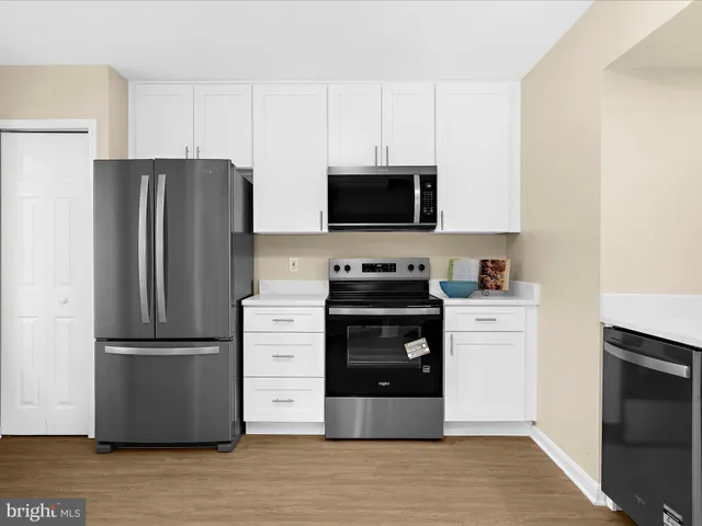 a kitchen with a refrigerator stove and microwave
