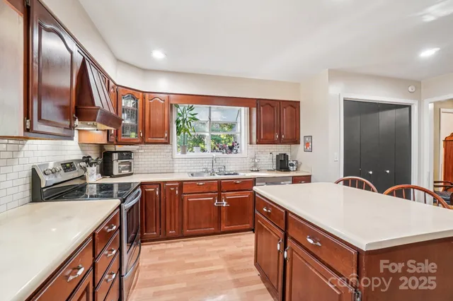 a kitchen with stainless steel appliances a refrigerator and wooden floor