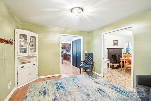 a view of a livingroom with wooden floor and a ceiling fan