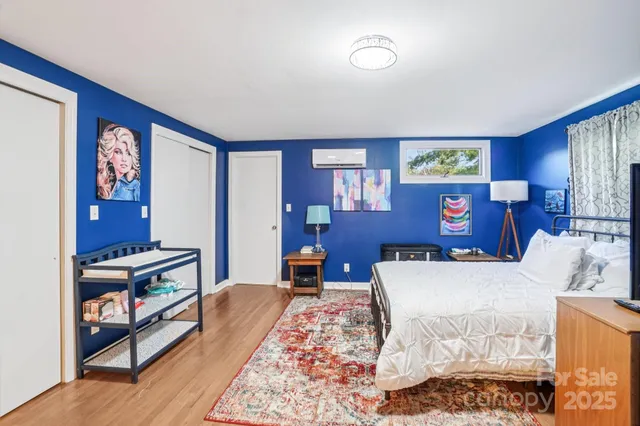 a bedroom with a bed and a dresser in it