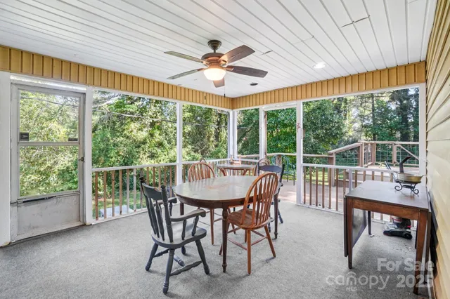 a view of a chairs and table on the wooden deck
