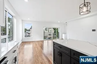 a spacious bathroom with a granite countertop sink and a large mirror