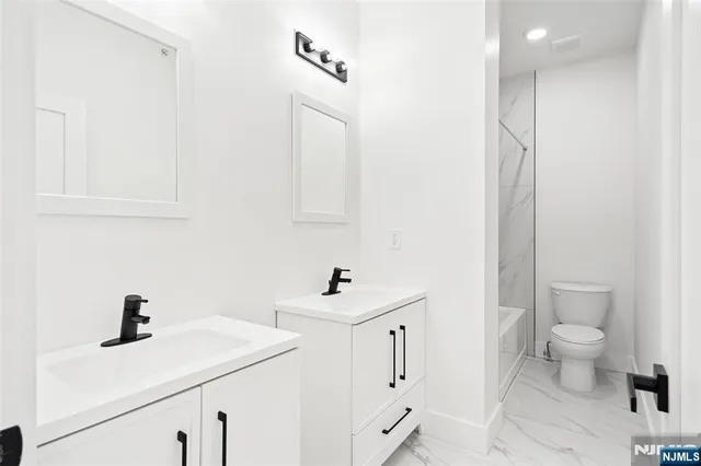 a bathroom with a sink toilet and mirror