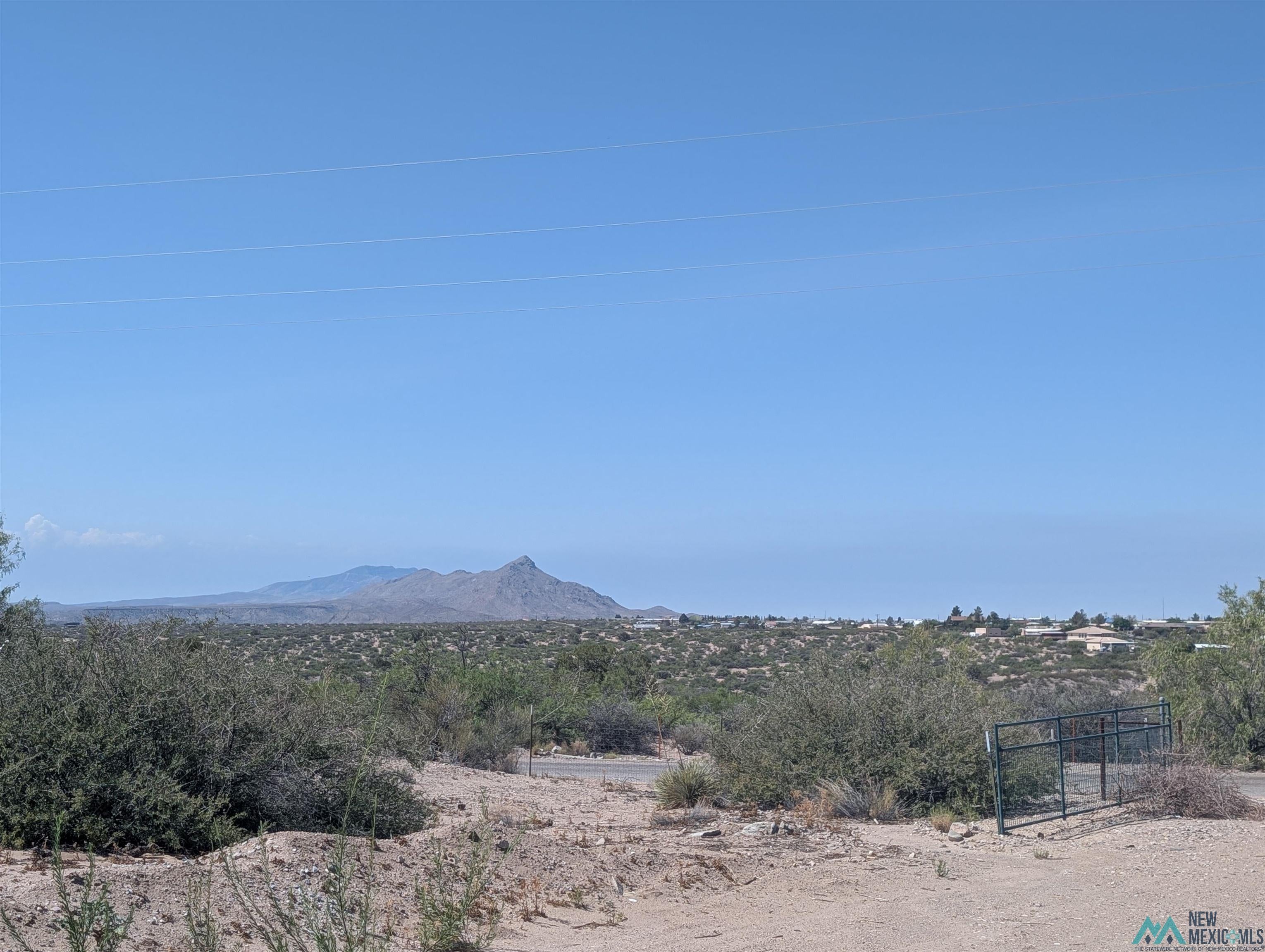 506 Bass Road Elephant Butte, NM 87935 - Photo 16 of 23 Expansive desert landscape with distant mountains under a clear sky