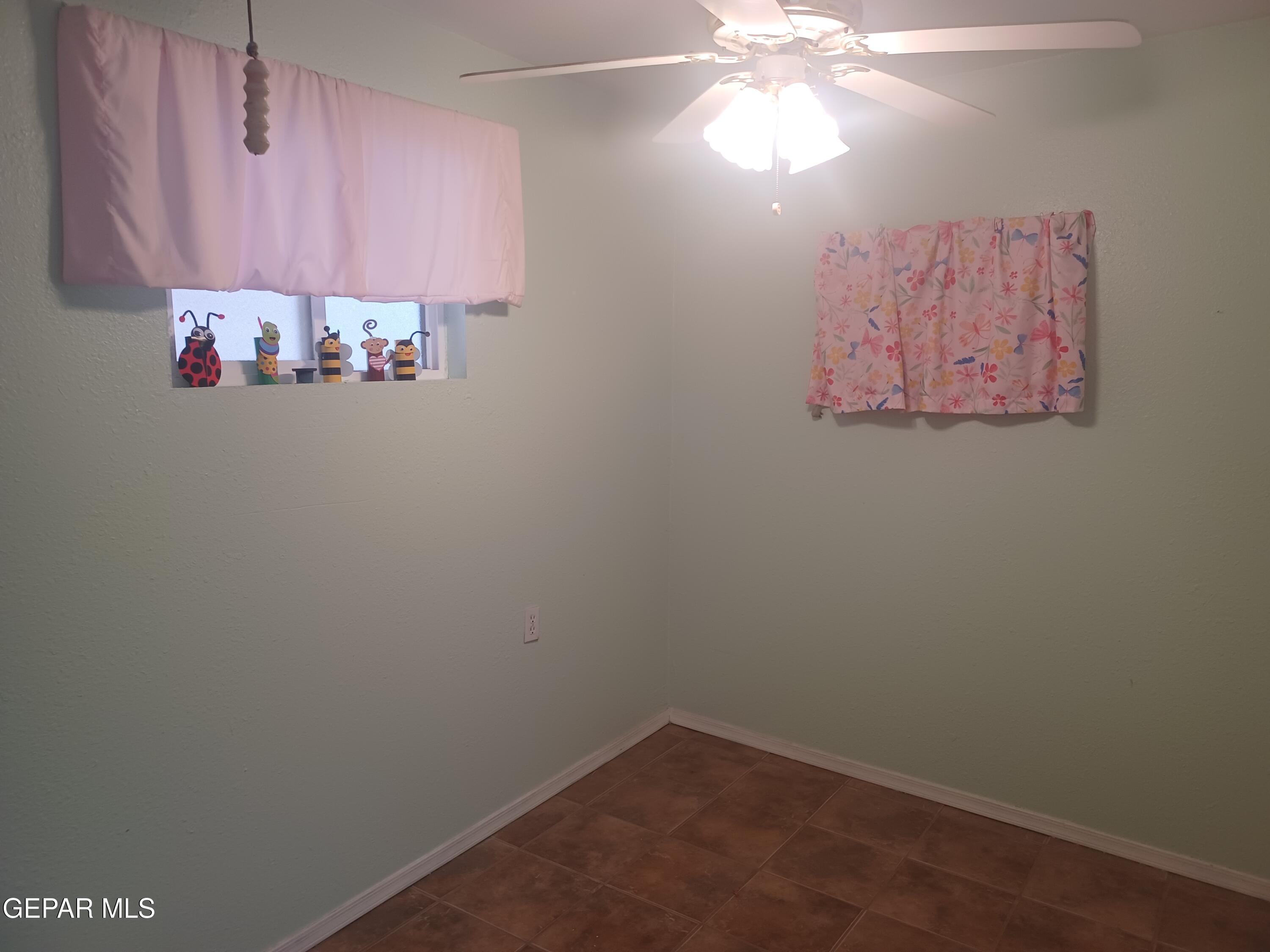 12400 Rojas Drive, Unit 103 El Paso, TX 79928 - Photo 18 of 43 a view of a room with window and a chandelier fan