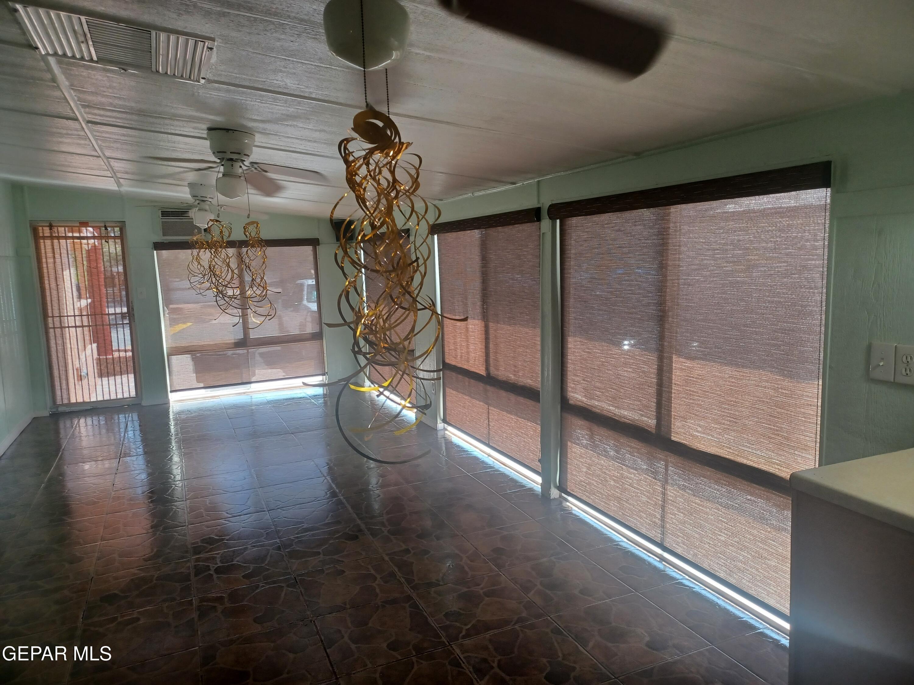 12400 Rojas Drive, Unit 103 El Paso, TX 79928 - Photo 23 of 43 a view of a hallway with a chandelier