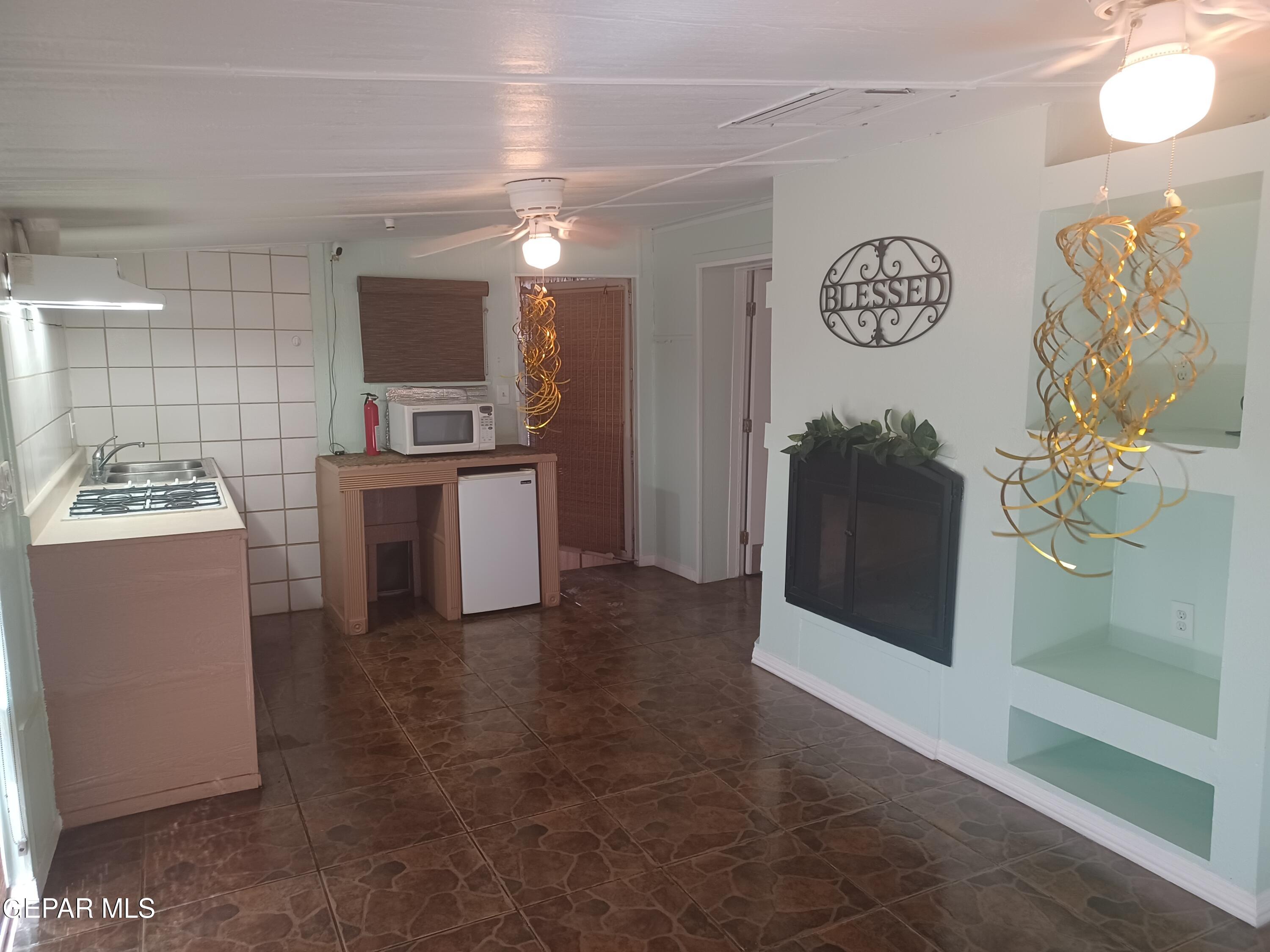 12400 Rojas Drive, Unit 103 El Paso, TX 79928 - Photo 24 of 43 a kitchen with granite countertop a sink and a stove top oven