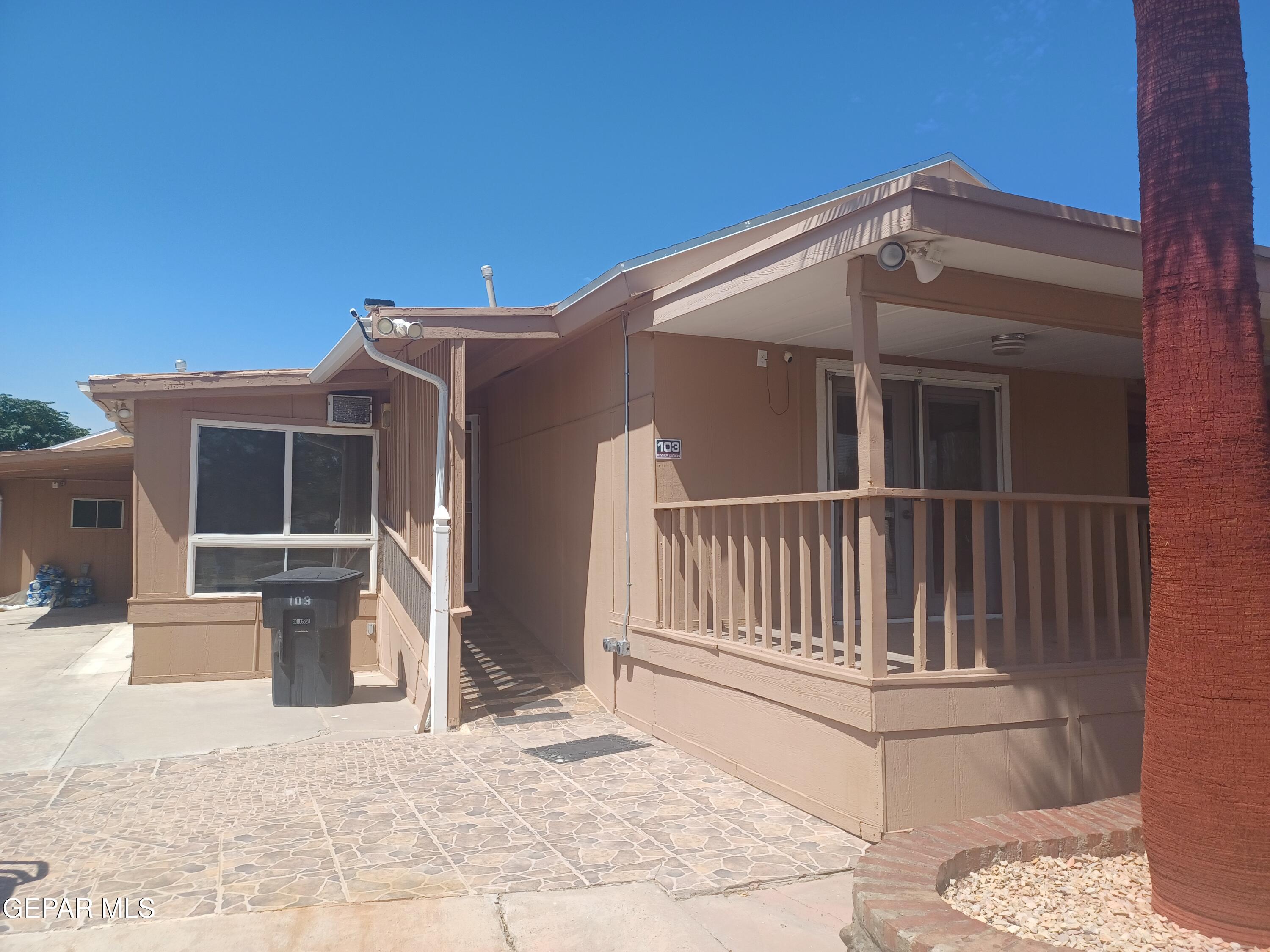 12400 Rojas Drive, Unit 103 El Paso, TX 79928 - Photo 3 of 43 a view of a house with a small yard and wooden floor and fence