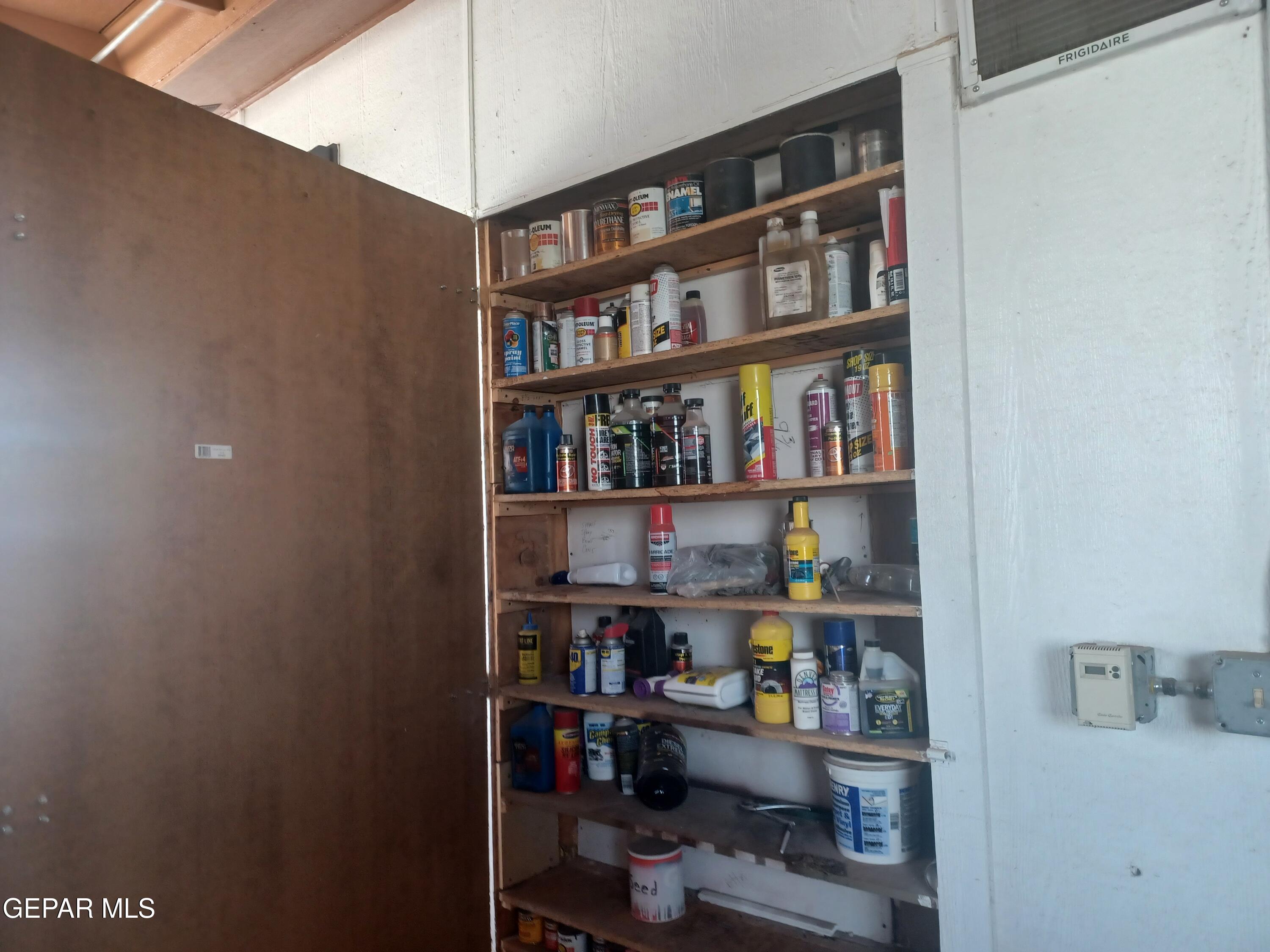 12400 Rojas Drive, Unit 103 El Paso, TX 79928 - Photo 35 of 43 a room with shelf and a book shelf