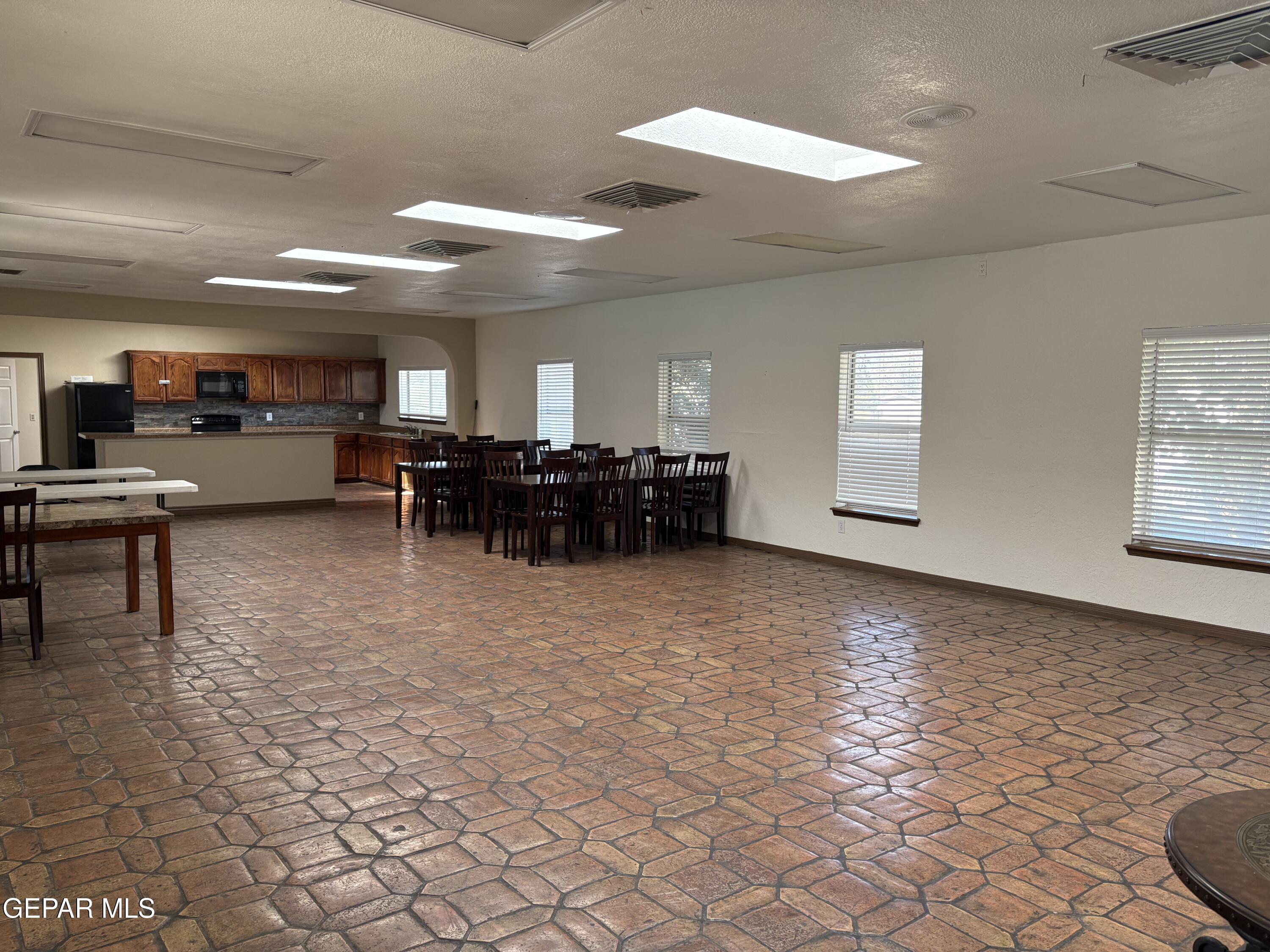 12400 Rojas Drive, Unit 103 El Paso, TX 79928 - Photo 43 of 43 a living room with furniture a dining table and kitchen view