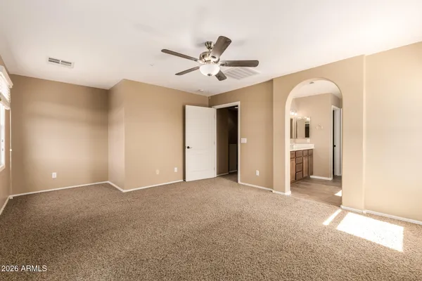 a view of a livingroom with a ceiling fan and window