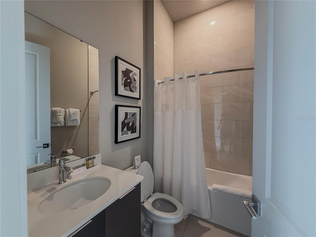 7770 Sandy Ridge Drive, Unit 231 Reunion, FL 34747 - Photo 13 of 25 a bathroom with a sink toilet and shower