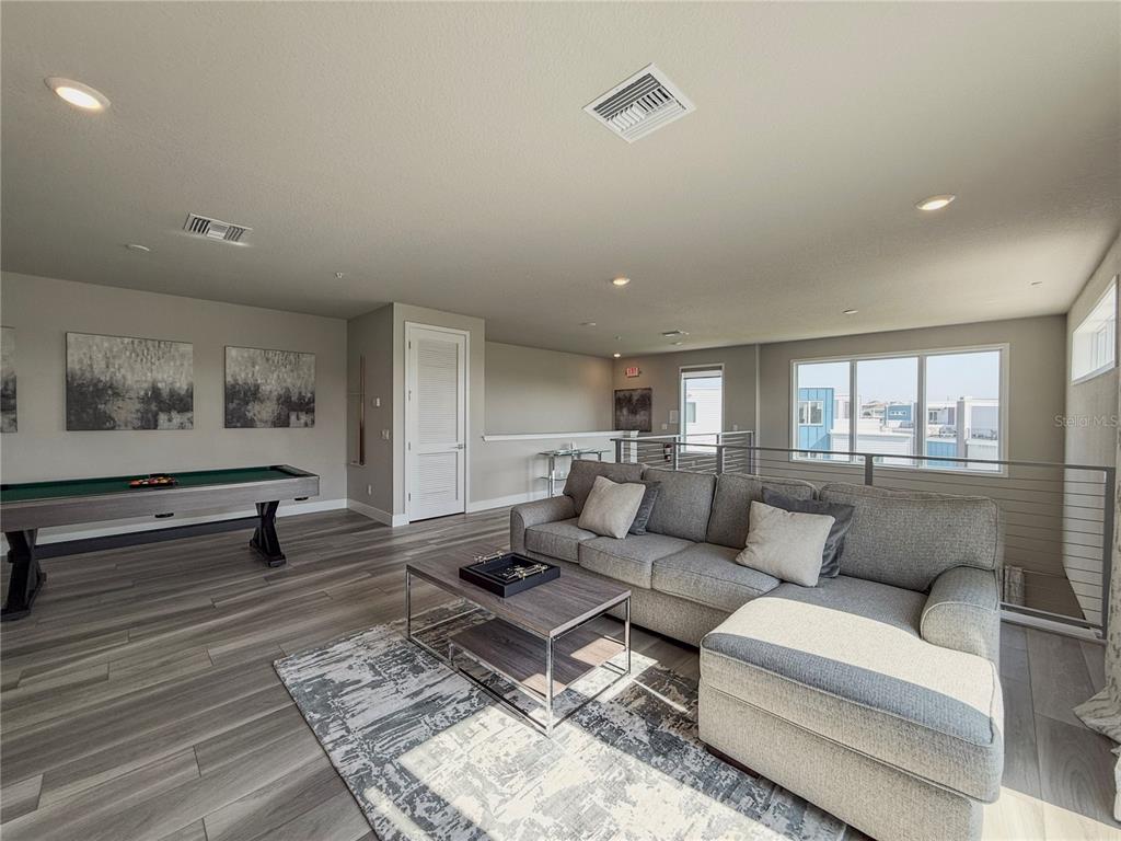 7770 Sandy Ridge Drive, Unit 231 Reunion, FL 34747 - Photo 17 of 25 a living room with furniture and wooden floor