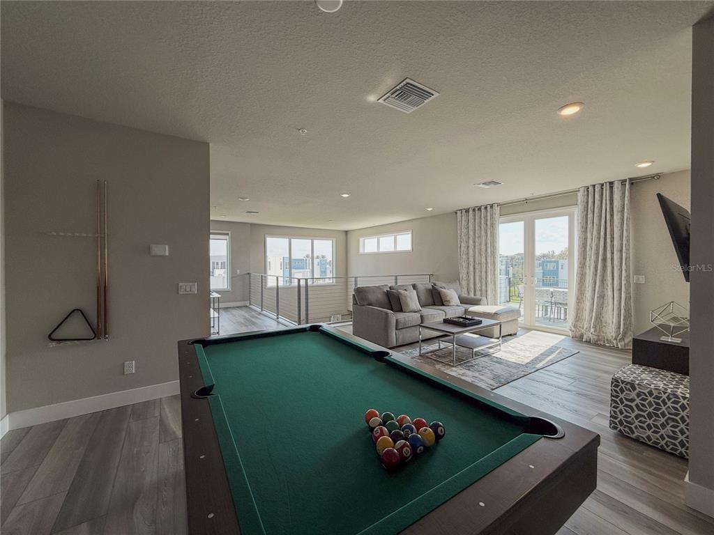 7770 Sandy Ridge Drive, Unit 231 Reunion, FL 34747 - Photo 18 of 25 a living room with furniture and a table