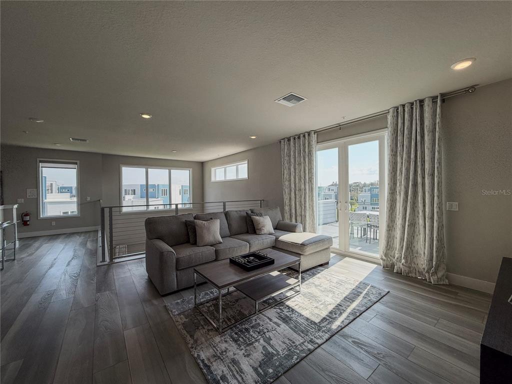 7770 Sandy Ridge Drive, Unit 231 Reunion, FL 34747 - Photo 19 of 25 a living room with furniture and wooden floor