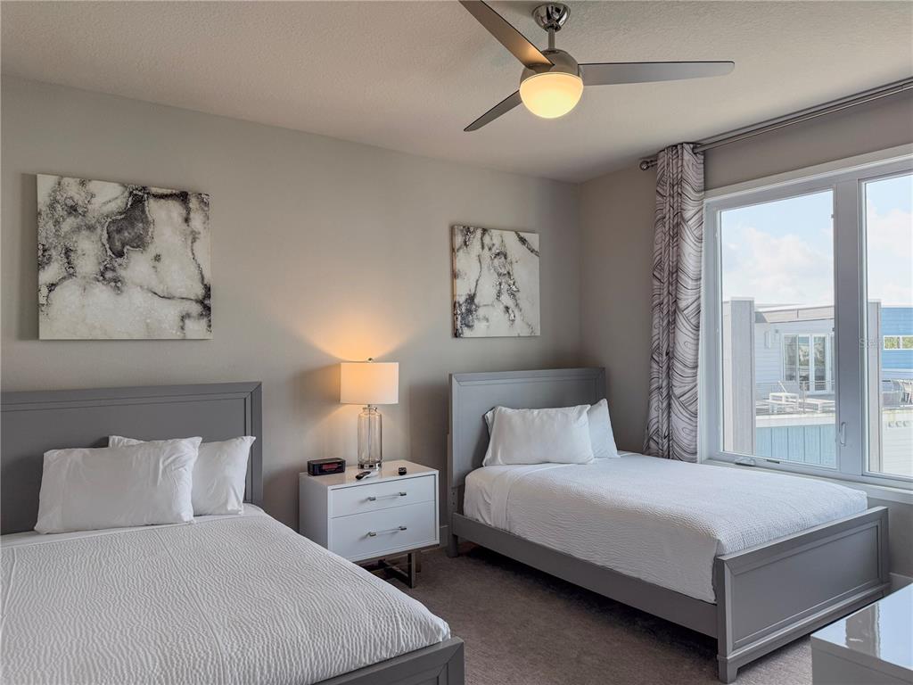 7770 Sandy Ridge Drive, Unit 231 Reunion, FL 34747 - Photo 20 of 25 a bedroom with a large bed and a chandelier
