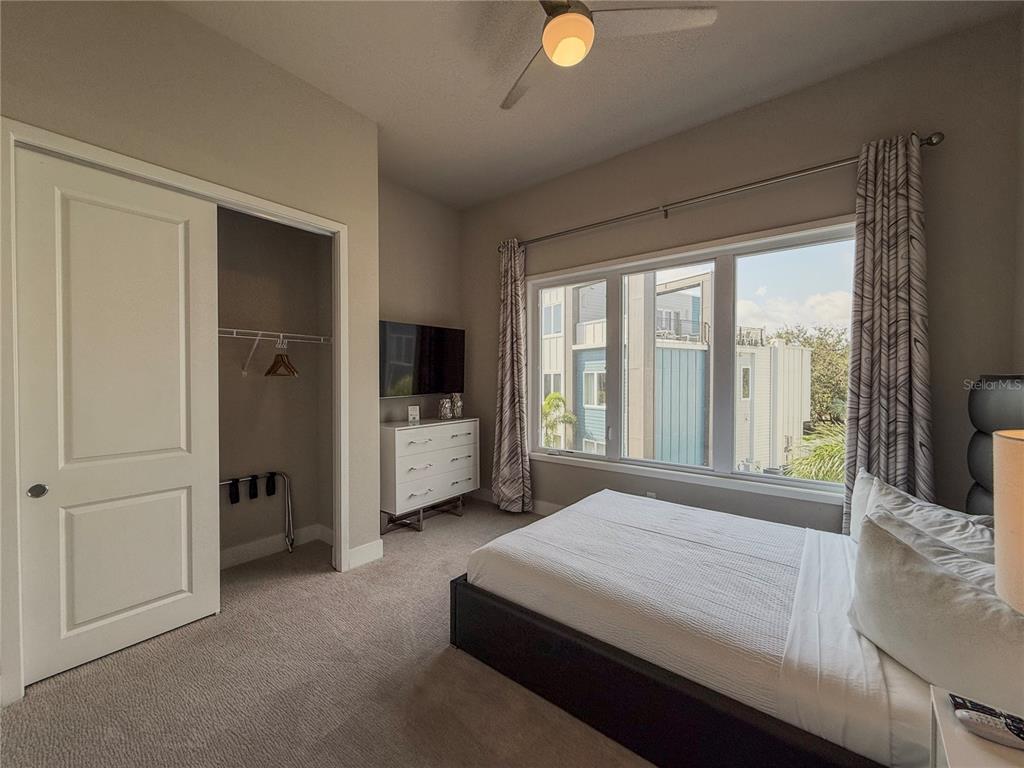 7770 Sandy Ridge Drive, Unit 231 Reunion, FL 34747 - Photo 8 of 25 a bedroom with a bed and a large window