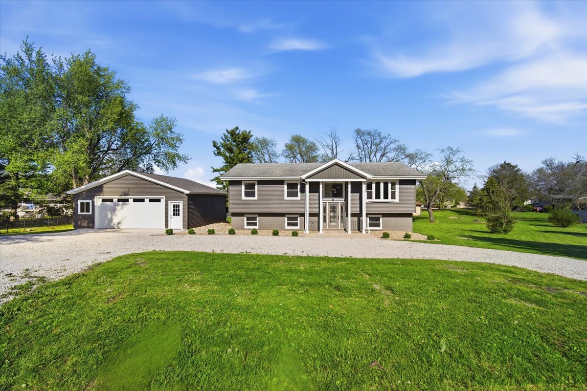 9646 Ridgewood Court Bloomington, IL 61705 - Photo 2 of 43 a front view of a house with garden