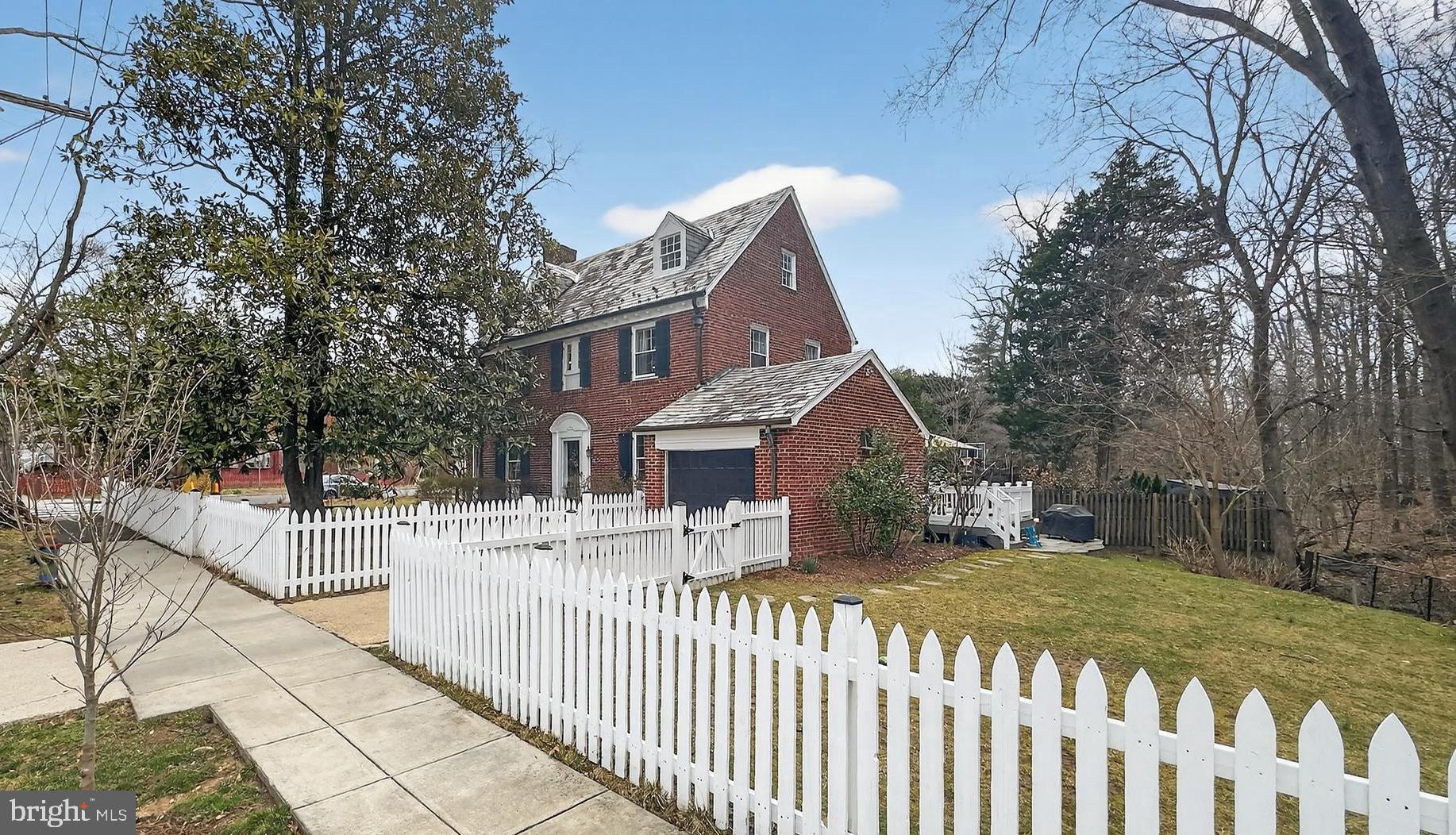5445 30th Street Northwest Washington, DC 20015 - Photo 1 of 46 a front view of a house with a yard