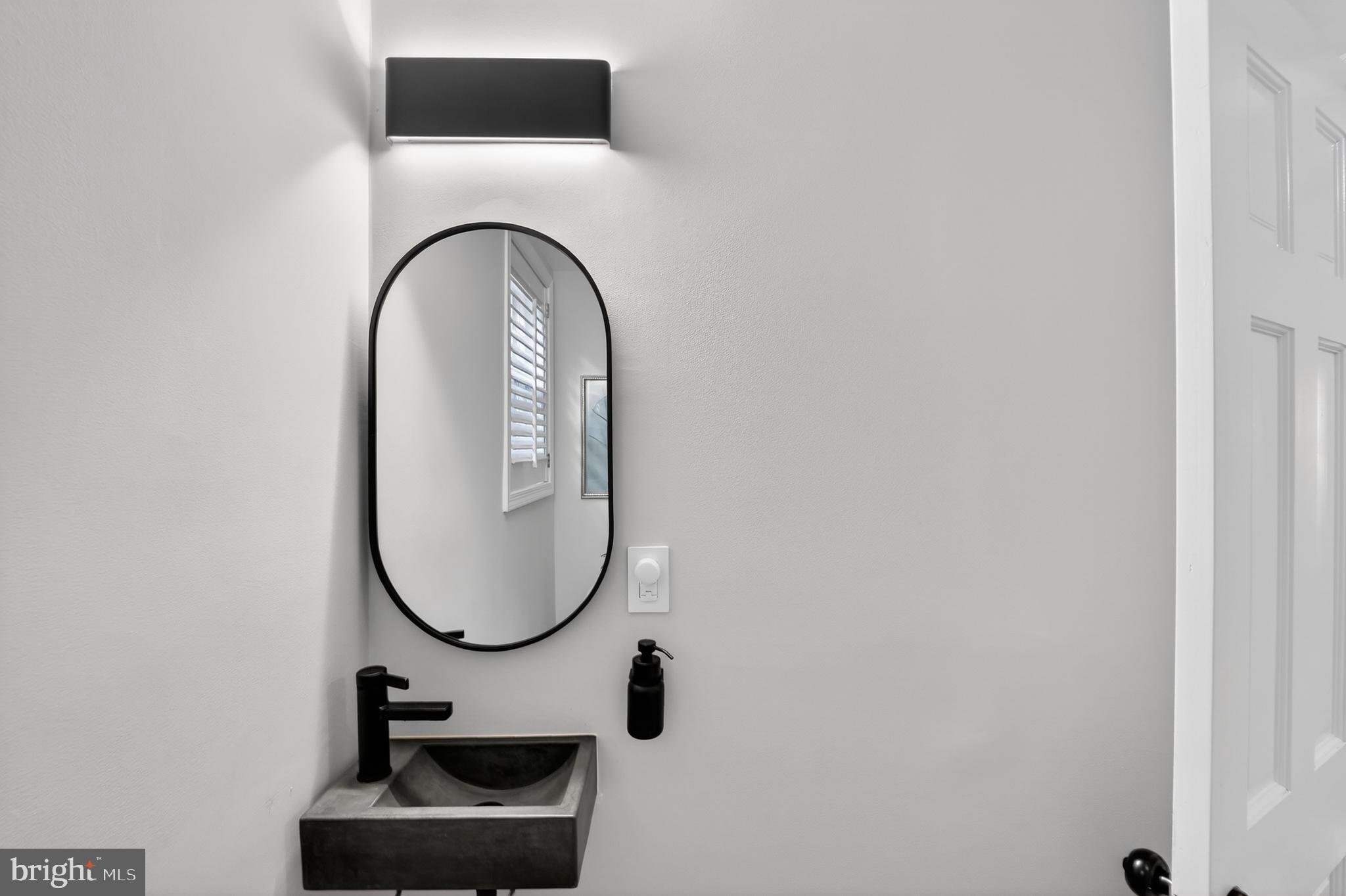 5445 30th Street Northwest Washington, DC 20015 - Photo 12 of 46 a bathroom with a sink and a mirror