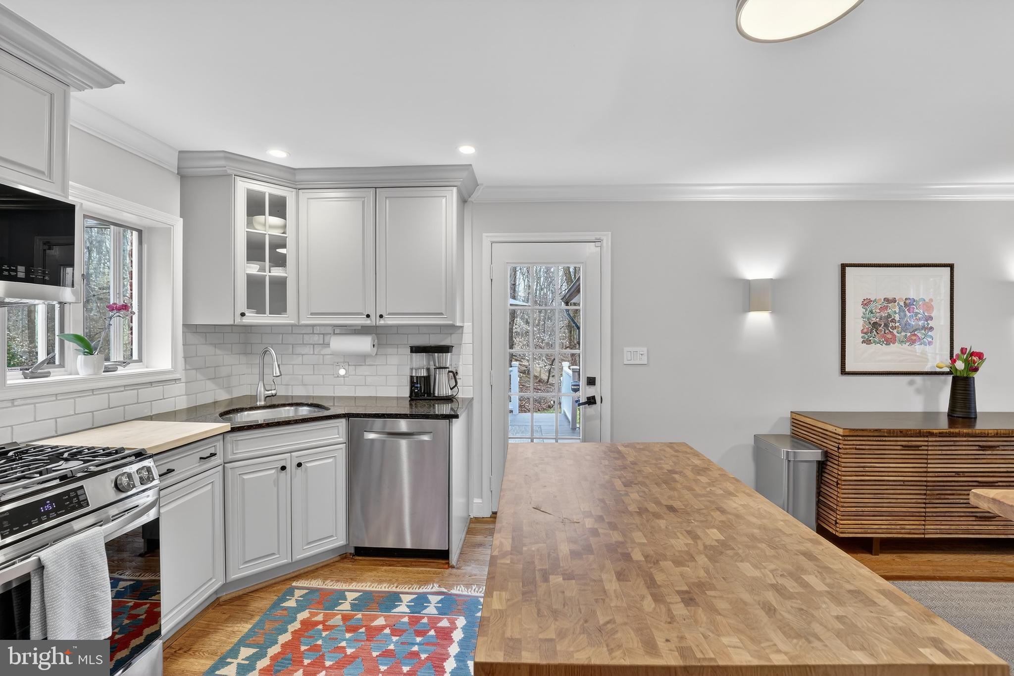 5445 30th Street Northwest Washington, DC 20015 - Photo 16 of 46 a kitchen with stainless steel appliances granite countertop a stove and a sink