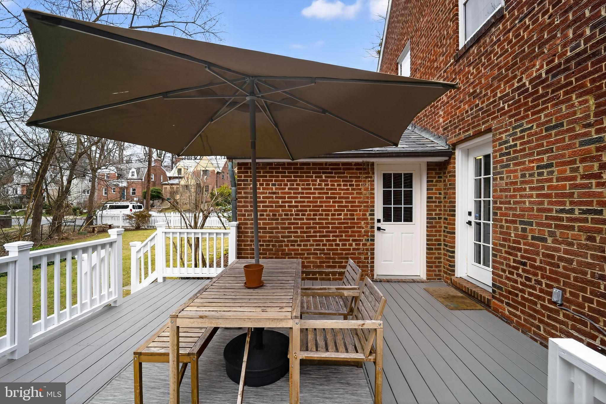 5445 30th Street Northwest Washington, DC 20015 - Photo 20 of 46 a view of deck with table and chair under an umbrella