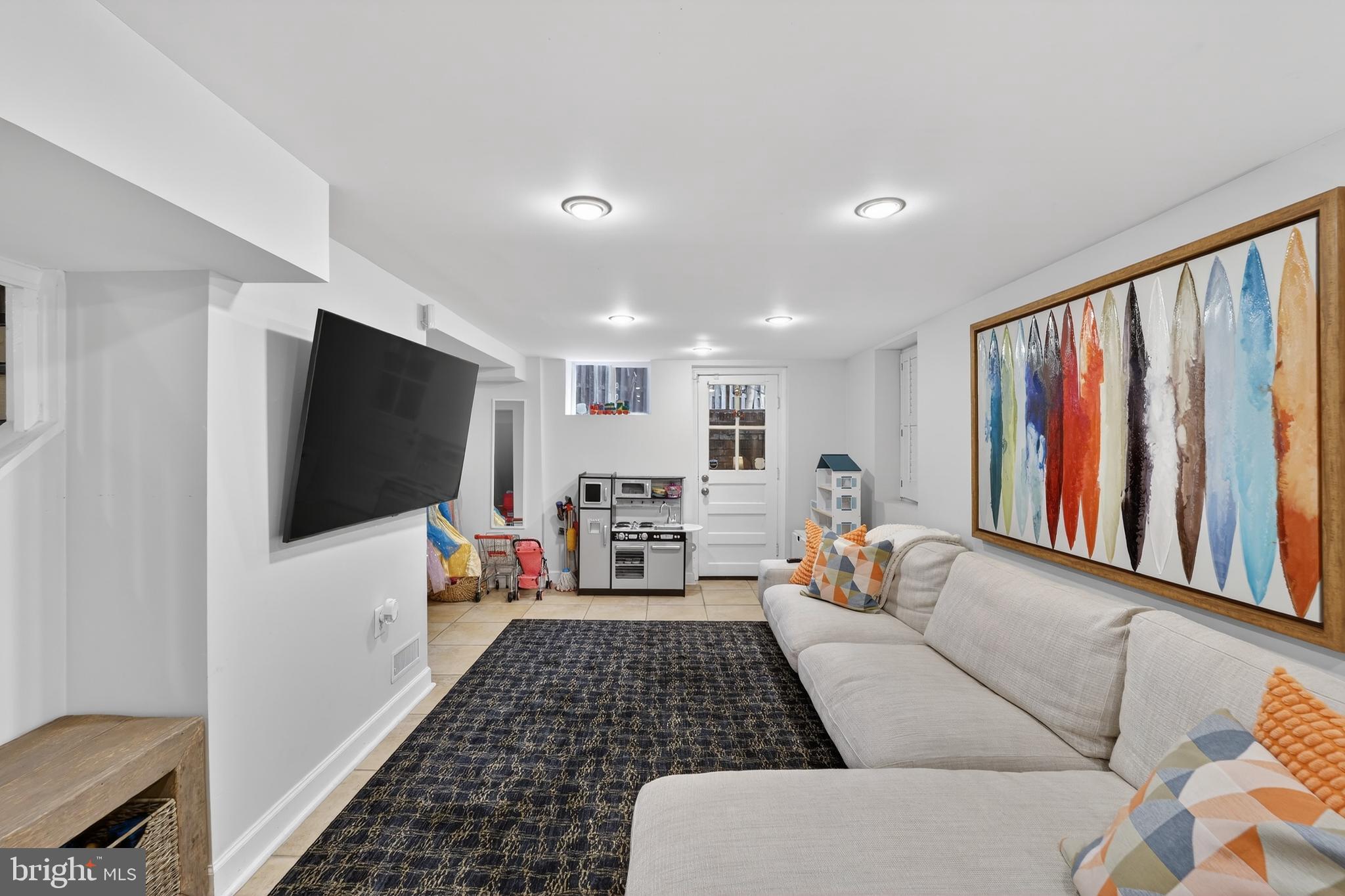 5445 30th Street Northwest Washington, DC 20015 - Photo 40 of 46 a living room with furniture and a flat screen tv
