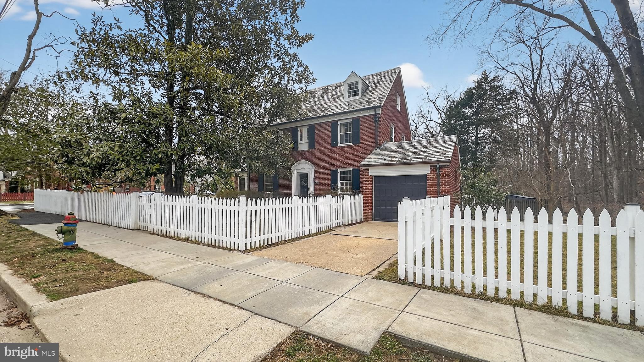 5445 30th Street Northwest Washington, DC 20015 - Photo 43 of 46 a view of a house with a small yard and wooden fence
