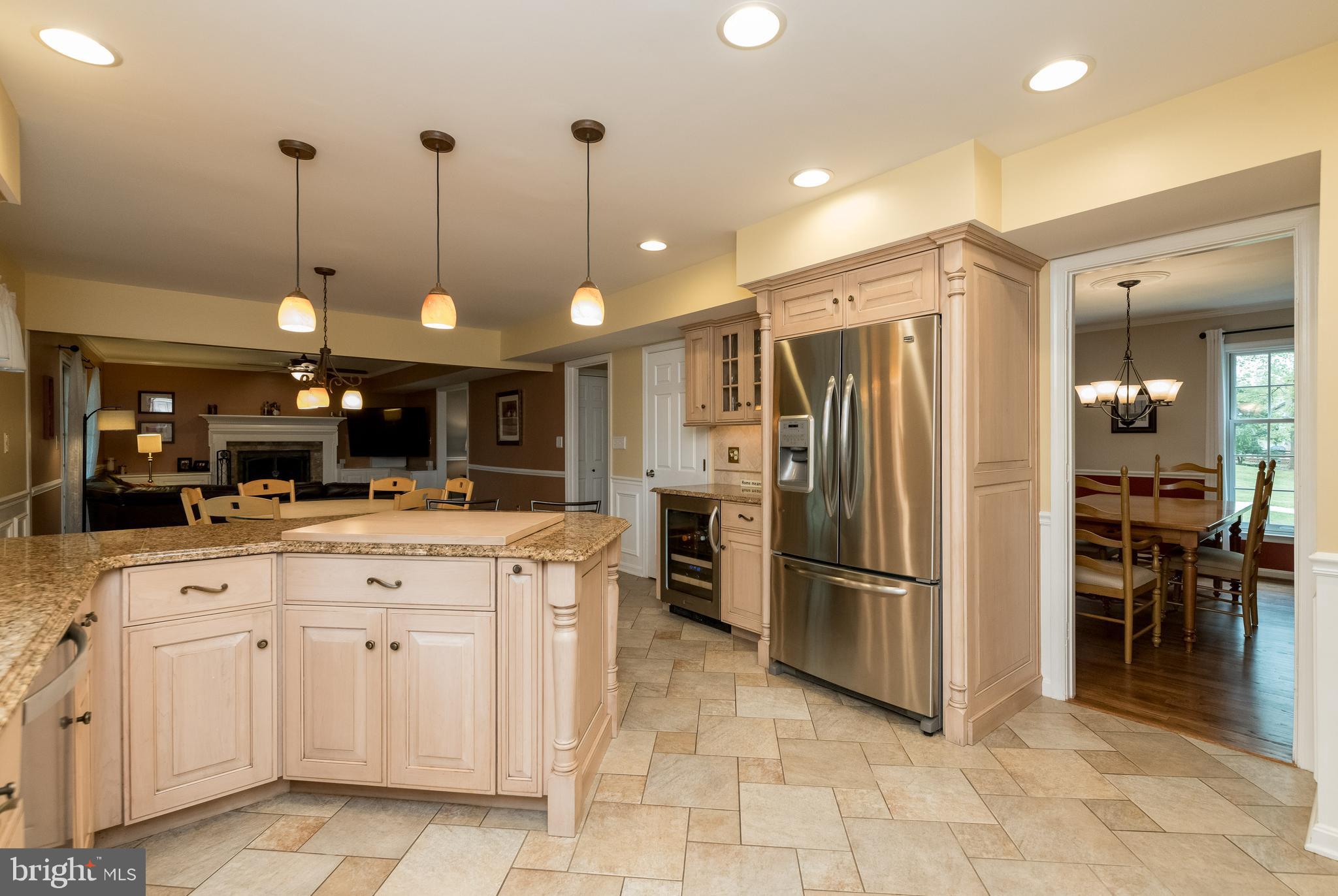 1007 Valewood Road Towson, MD 21286 - Photo 12 of 49 a kitchen with stainless steel appliances kitchen island granite countertop a refrigerator and a sink