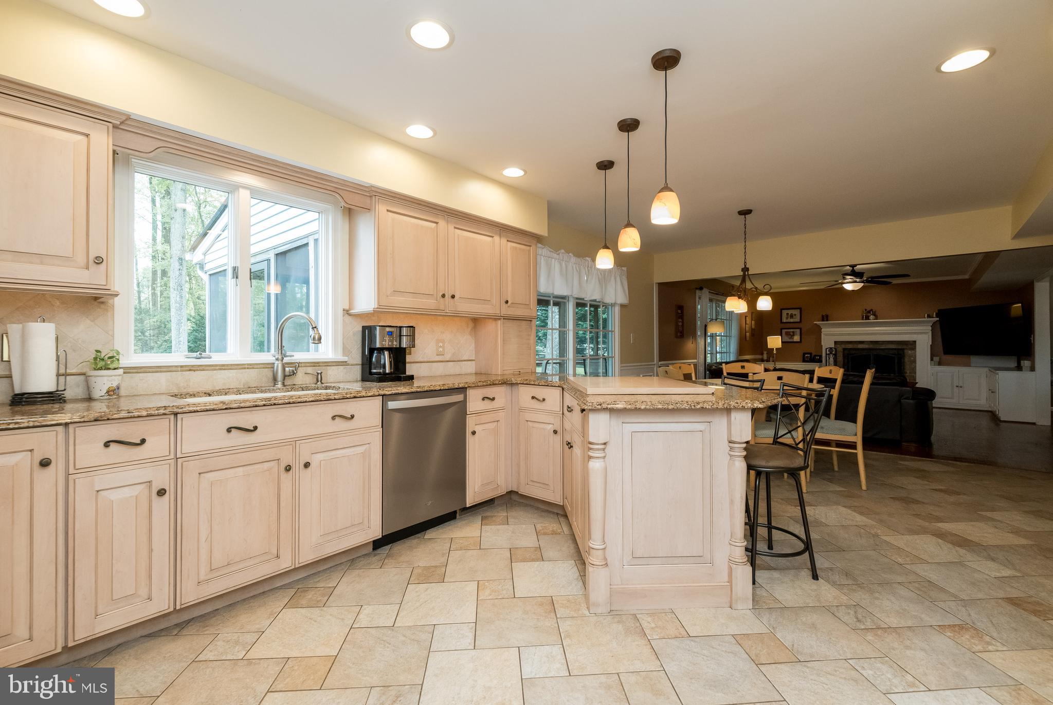 1007 Valewood Road Towson, MD 21286 - Photo 14 of 49 a kitchen with cabinets and chairs