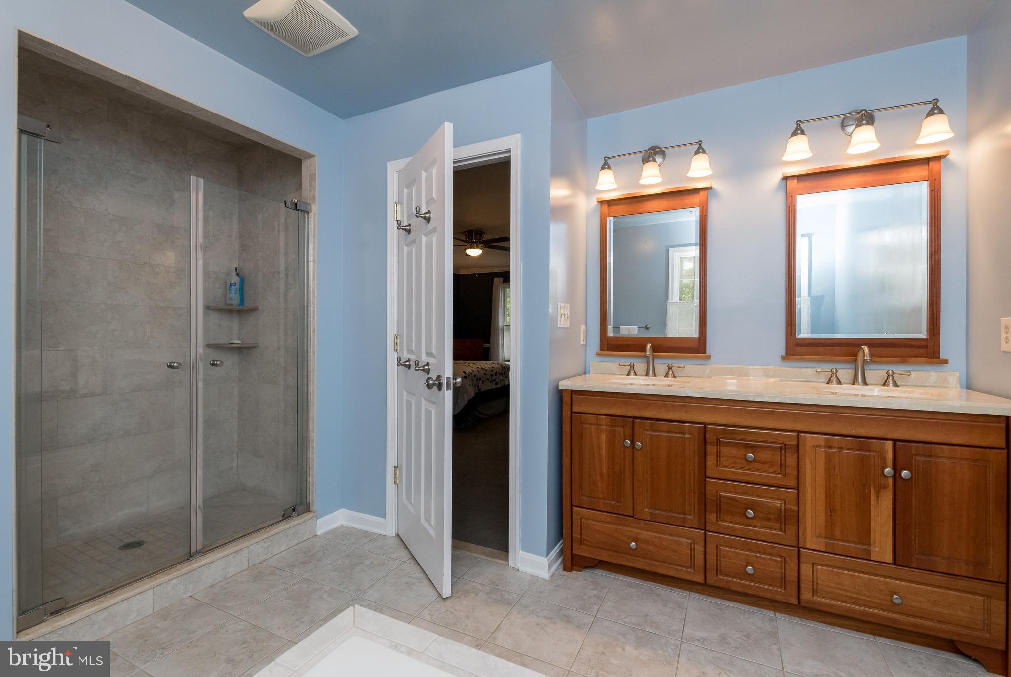 1007 Valewood Road Towson, MD 21286 - Photo 25 of 49 a spacious bathroom with double vanity and a mirror