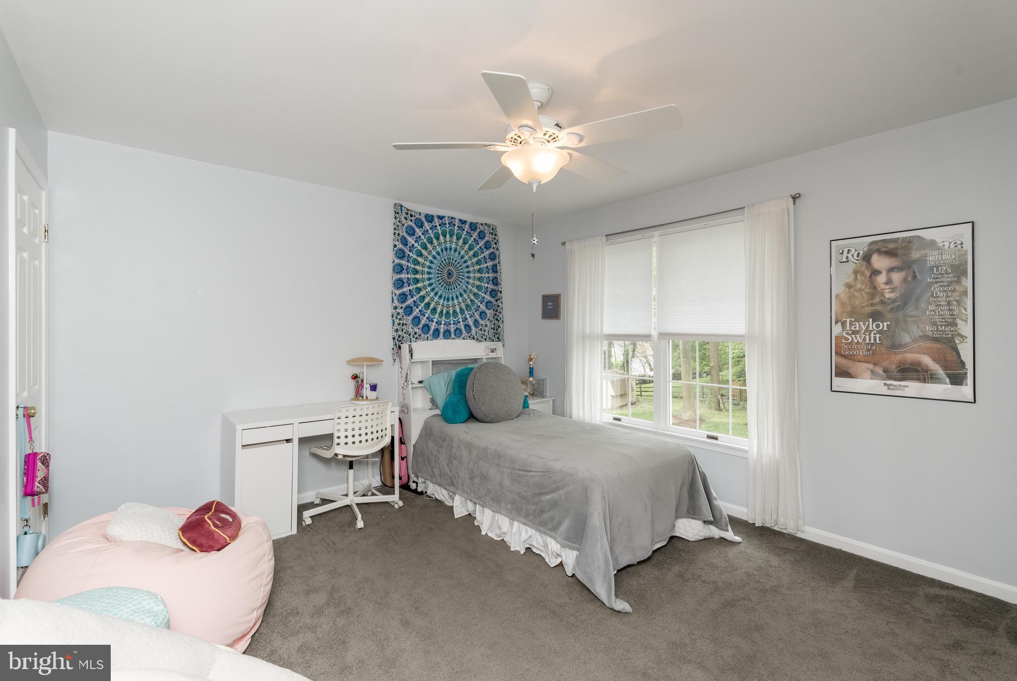 1007 Valewood Road Towson, MD 21286 - Photo 27 of 49 a bedroom with a bed and a chandelier