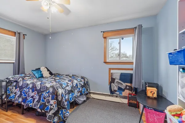 a bedroom with bed and a window