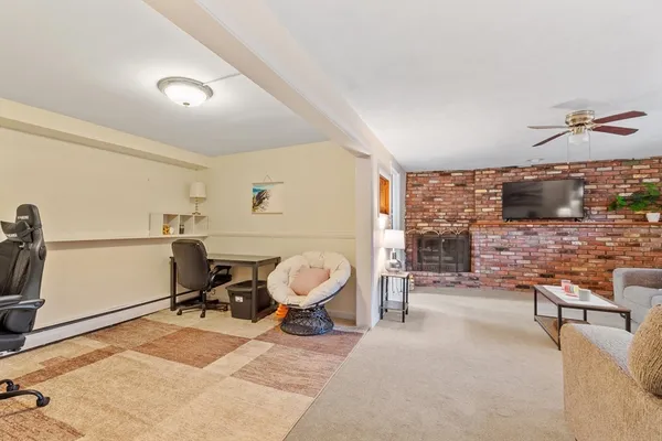 a living room with furniture a flat screen tv and a large window