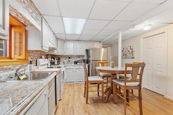 a kitchen with sink a counter space and appliances