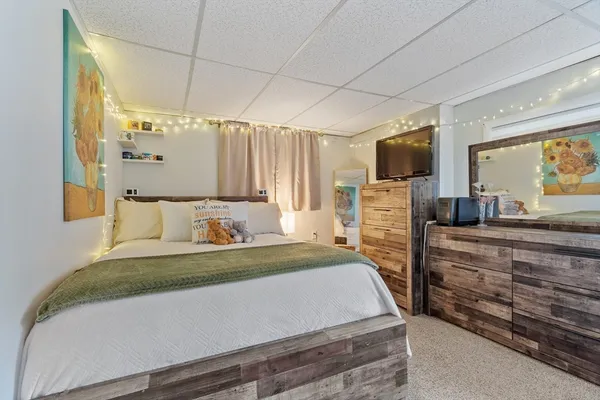 a bedroom with a bed and a flat screen television