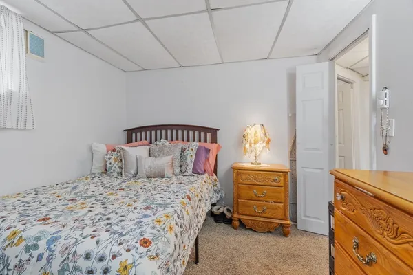a bedroom with a bed and a dresser