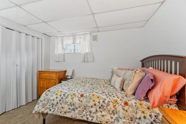 a bedroom with a bed and chair