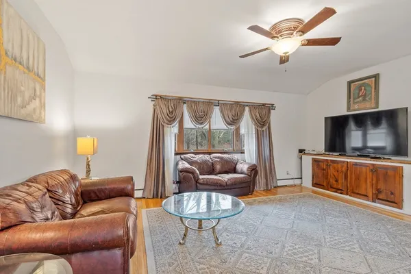 a living room with furniture and a flat screen tv