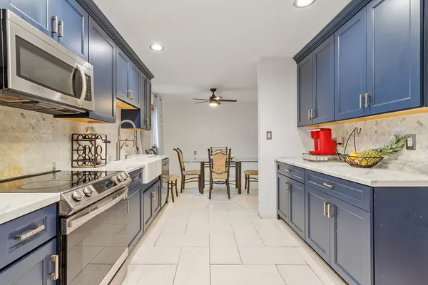 a kitchen with stainless steel appliances granite countertop a stove and a sink