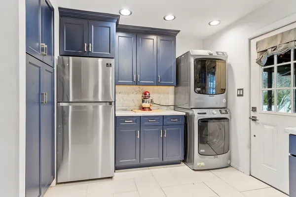 a kitchen with stainless steel appliances granite countertop a refrigerator and a stove top oven